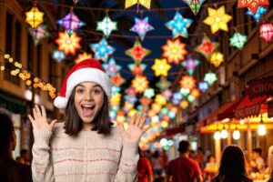 città illuminata da tante piccole luci sospese e donna entuasiata